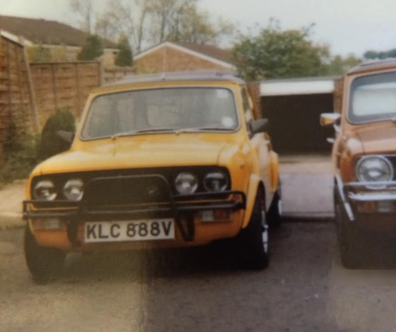 Image of a yellow Wood & Pickett Mini 1275GT from 1980 with original number plate visible